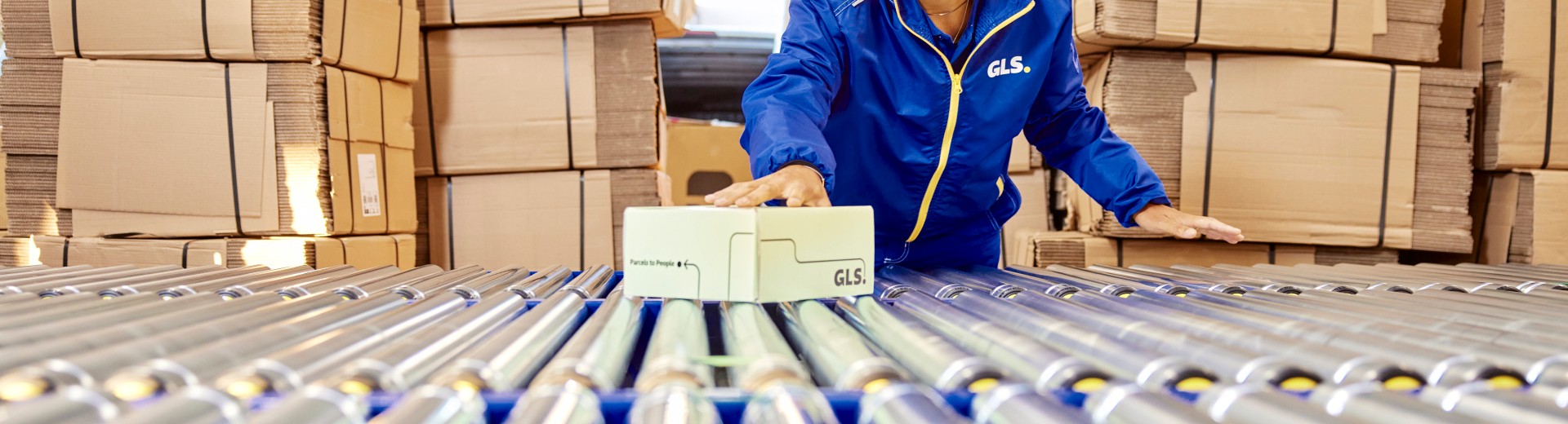 Conveyor belt and cardboard boxes at the background