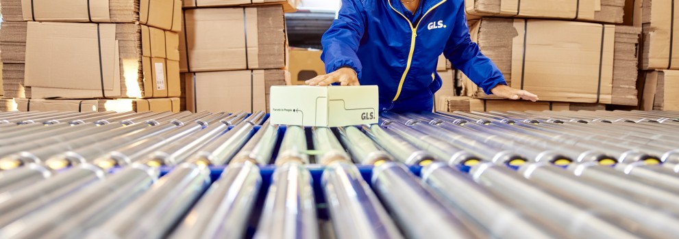 Conveyor belt and cardboard boxes at the background