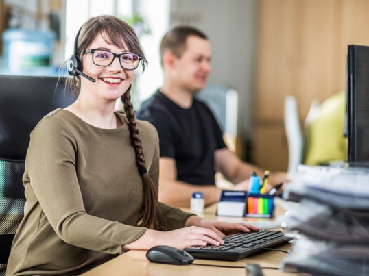 Happy girl working on the GLS call center