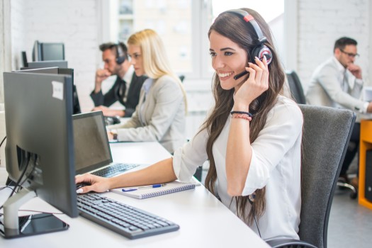 Customer service agent smiling with a headset.